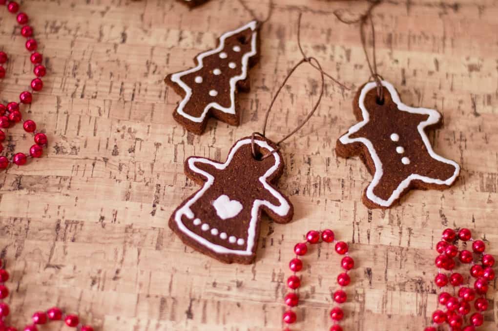 Cinnamon Ornaments on a corkboard with red beads. 