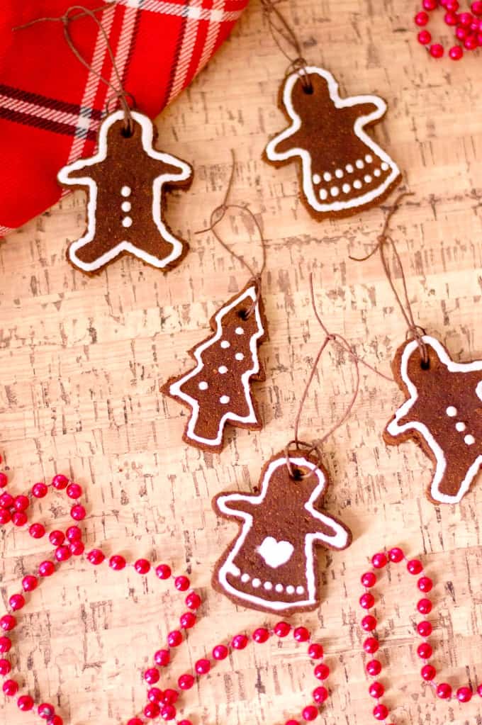 Cinnamon Ornaments on a cork board with red beads and plaid scarf