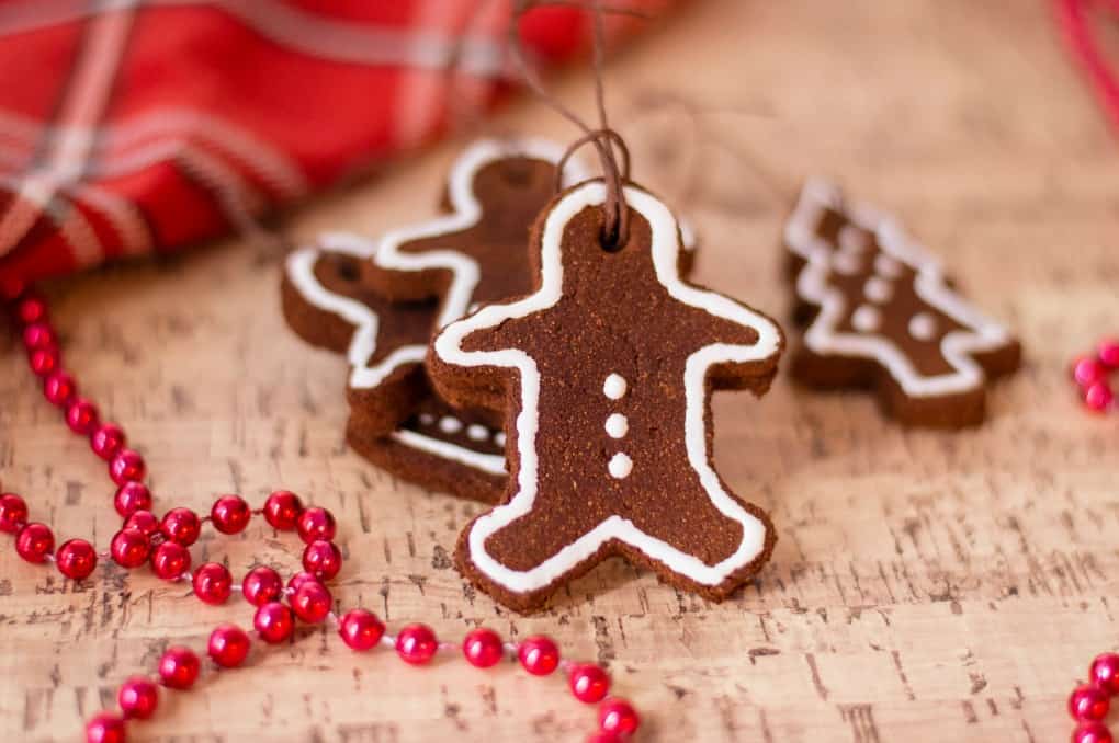 Stacked cinnamon ornaments on cork board with red beads