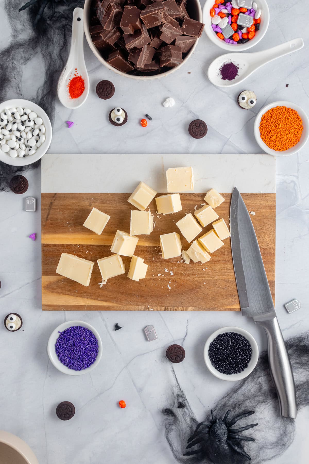 Chopping white chocolate in even pieces.