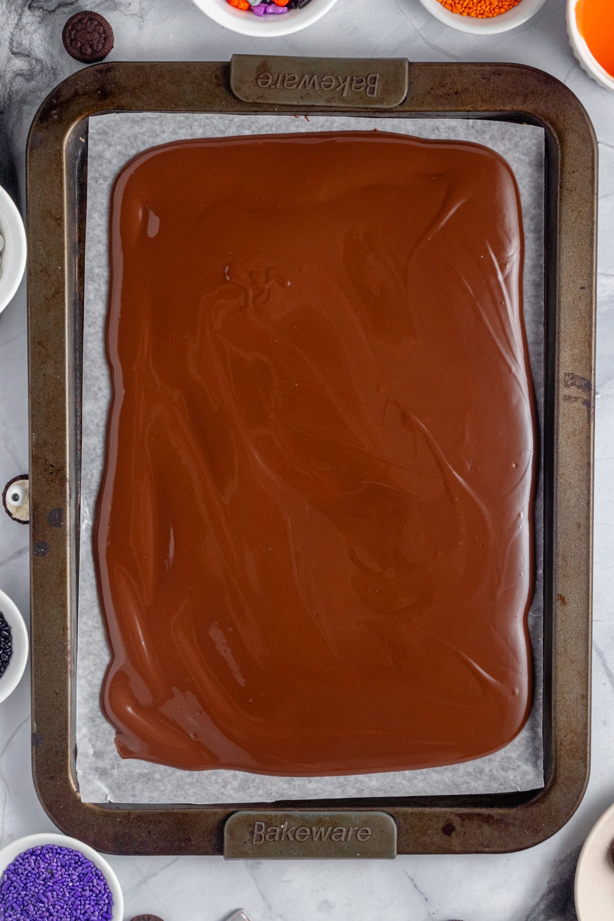 Melted chocolate extended over a baking sheet.