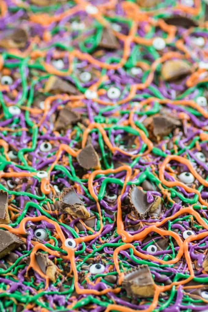 Purple, green and orange Halloween Bark with eyeballs and peanut butter cups