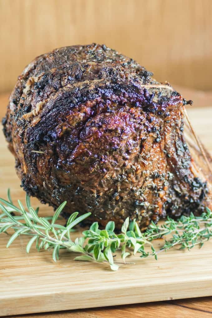 Roast Beef with fresh herbs on a cutting board