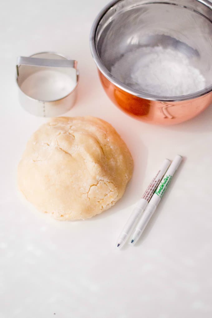 Cookie dough with edible markers and cookie cutter