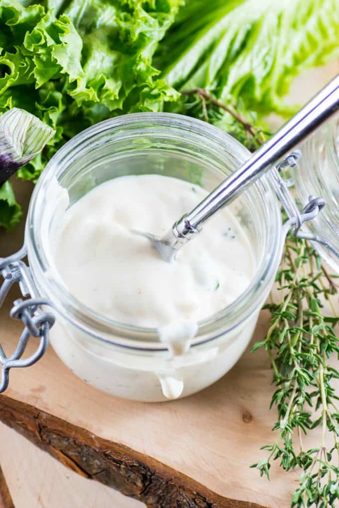 Buttermilk Ranch Dressing in a jar with a spoon closeup. 