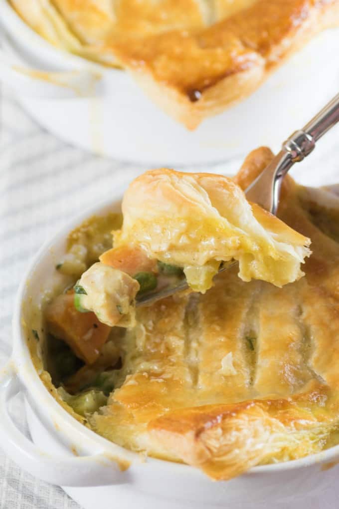 Curried Turkey Pot Pie in a ramekin dished out with a fork. 