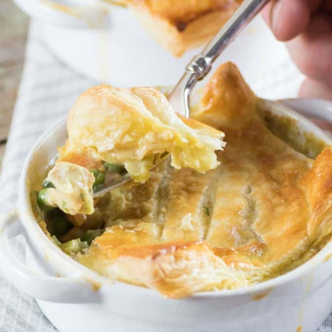 Curried Turkey Pot Pie in a ramekin and dished up with a fork