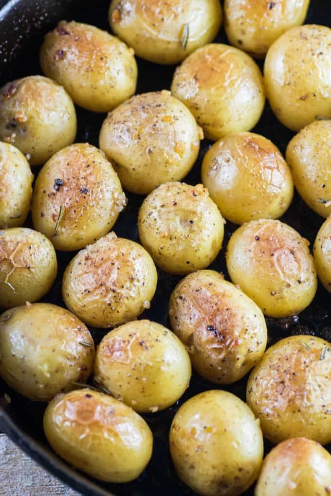 Garlic Rosemary Fondant Potatoes in a cast iron pan