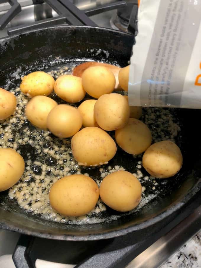 Creamer potatoes going into a cast iron pan
