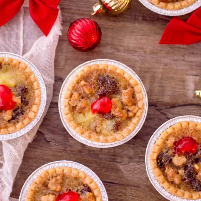Holiday Mini Butter Tarts on a wooden board with decorations