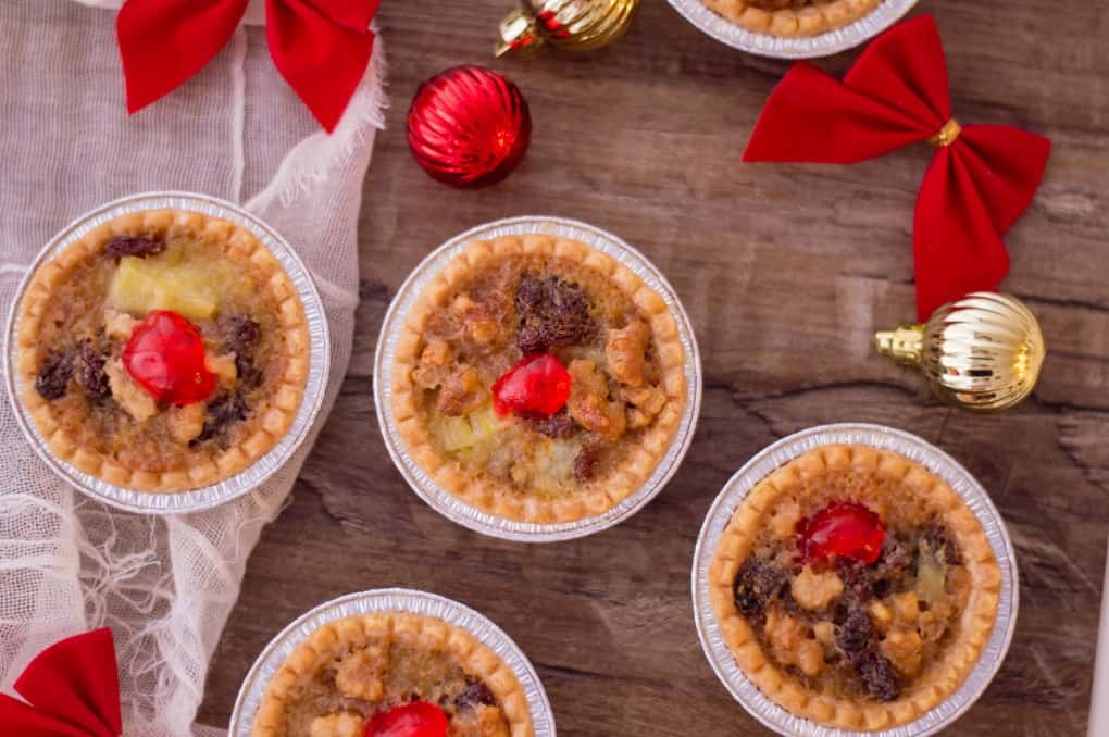 Holiday Mini Butter Tarts on a wooden board with decorations