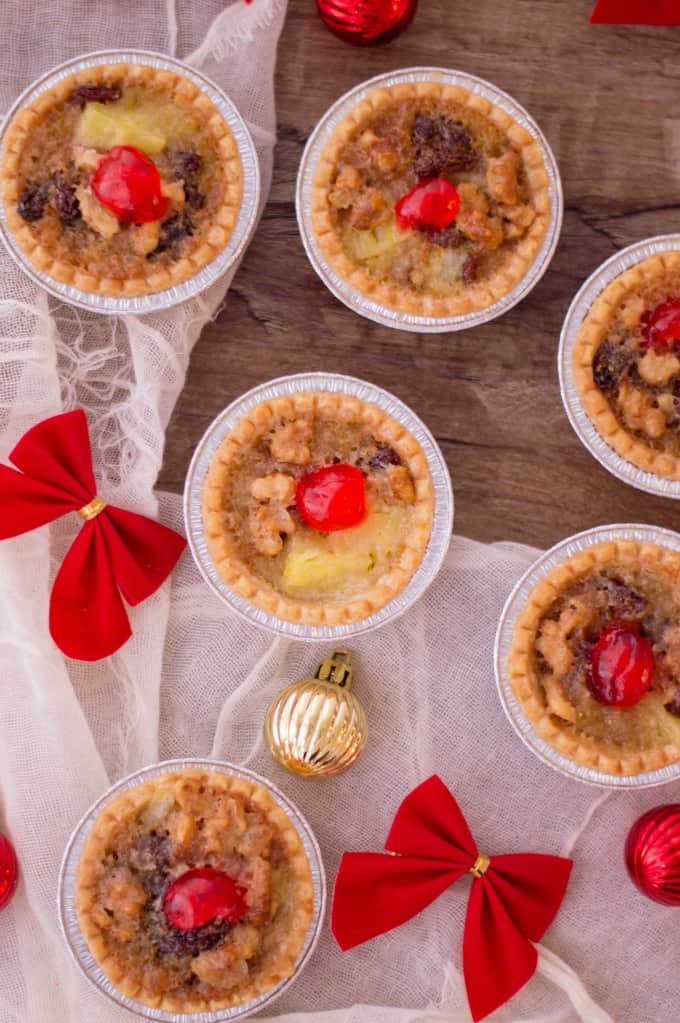 Holiday Mini Butter Tarts on a wooden board with decorations