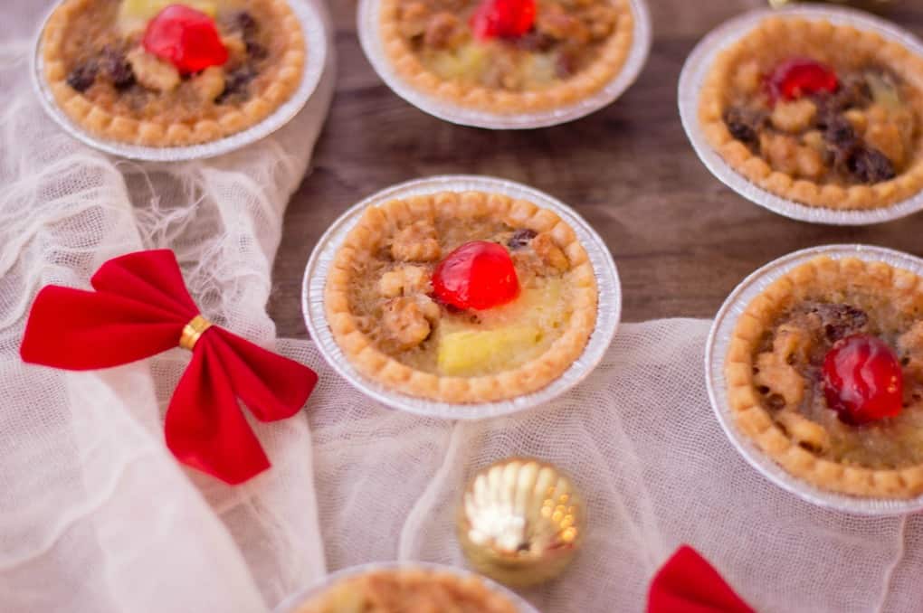 Holiday Mini Butter Tarts on a wooden board with decorations