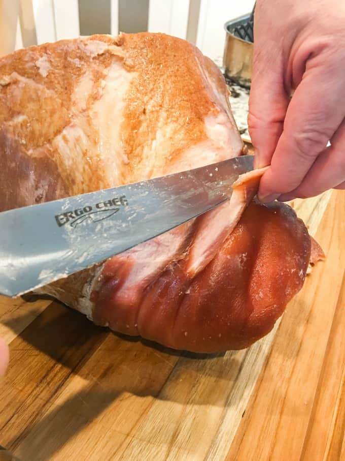 Removing skin from a ham. 