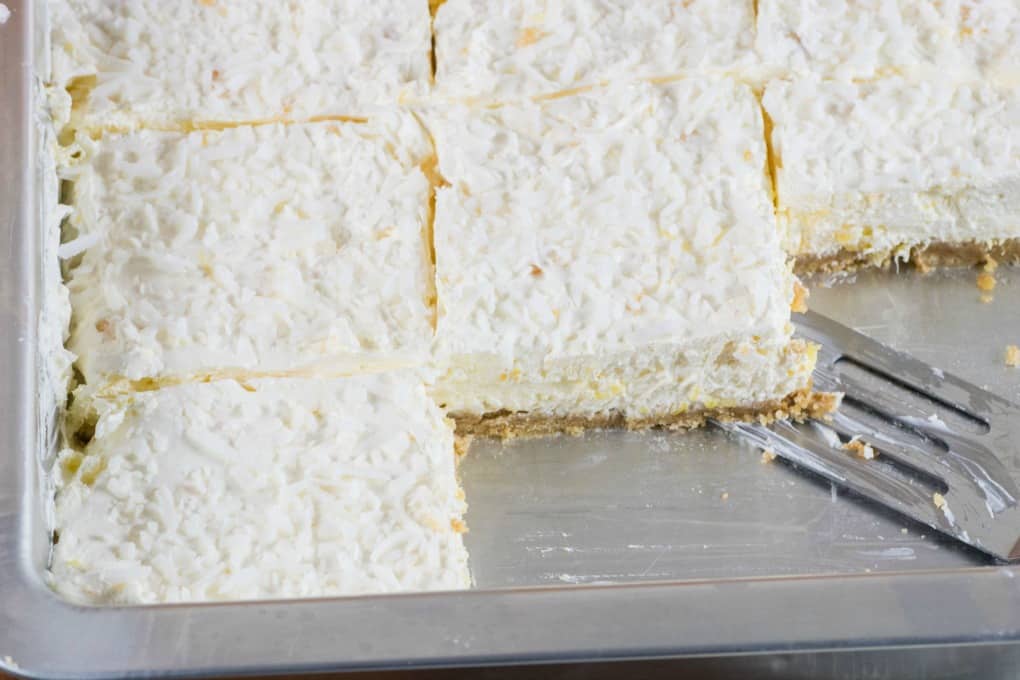 Pineapple Dream Dessert cut into bars in a pan