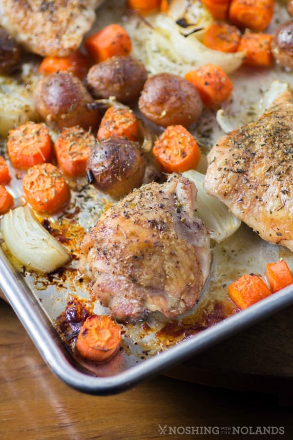 Roasted Chicken Thighs with Carrot, Potatoes and Onions on a Sheet Pan. 