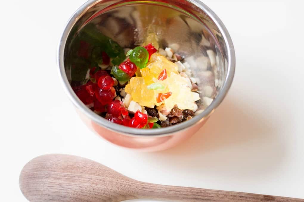 Best Ever Fruitcake Cookies ingredients in a bowl with a wooden spoon. 