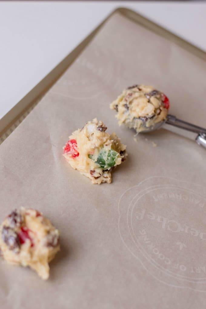Cookie dough on a parchment lined baking sheet. 