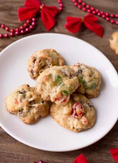 Best Ever Fruitcake Cookies on a white plate with Christmas decor.