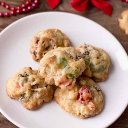 Best Ever Fruitcake Cookies on a white plate with Christmas decor.
