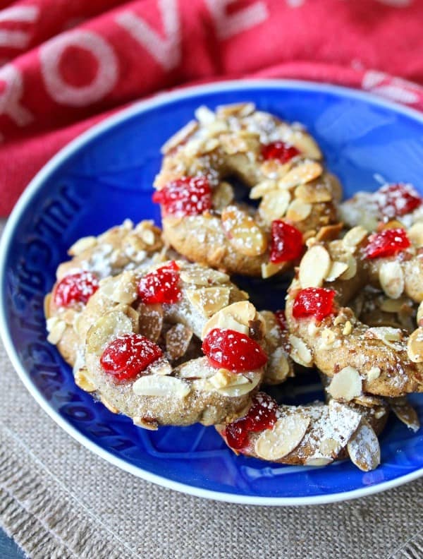 Almond-Spice Christmas Wreath Cookies on a blue plate.