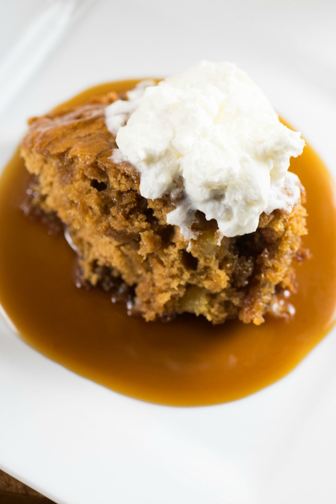 Easy Apple Brandy Sticky Toffee Pudding on a white plate with whipped cream
