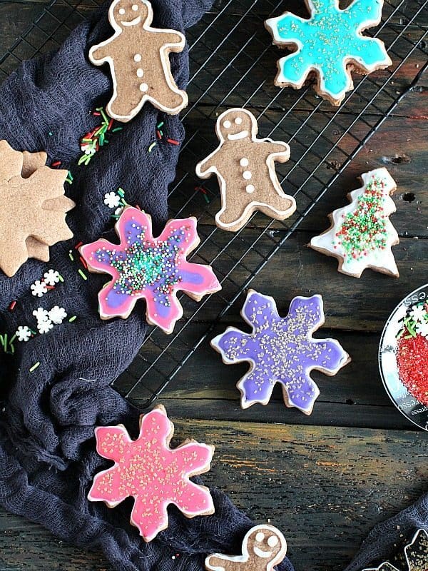 Assorted Neon Chocolate Christmas Cookies on a cooling rack with a black cloth. 