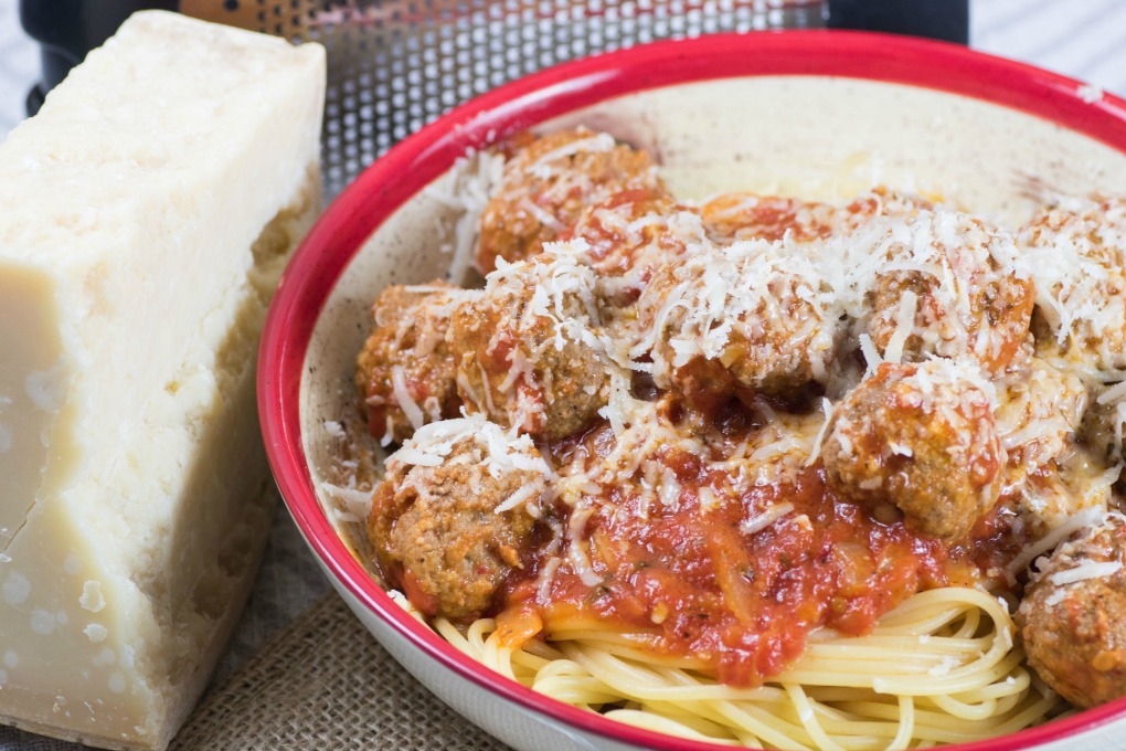 Spaghetti and Meatballs in Marinara Sauce in a bowl with Parmesan cheese