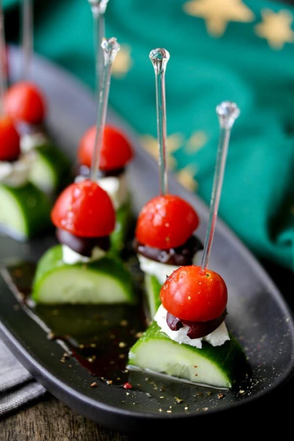 Greek salad skewer appetizers on a black serving plate 