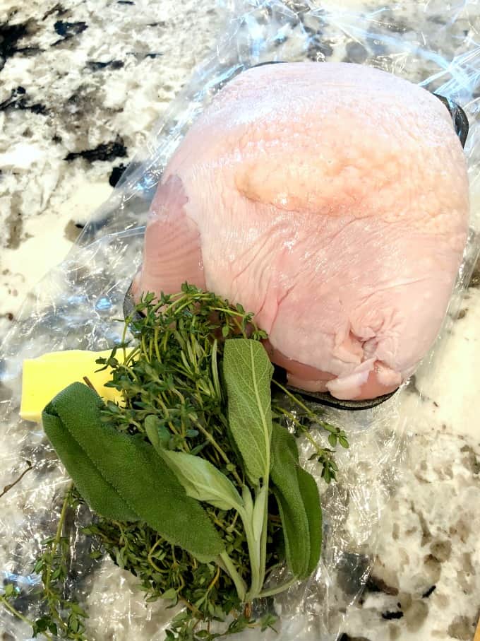 Raw turkey breast, fresh herbs and butter