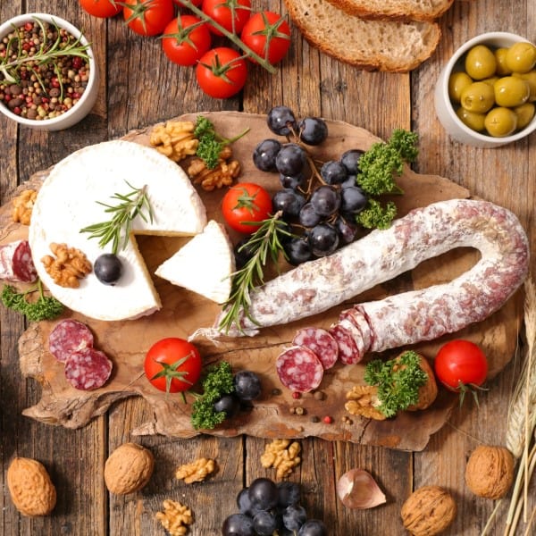 How to build the best charcuterie board various meats, cheeses, fruits olives and nuts on a wooden board