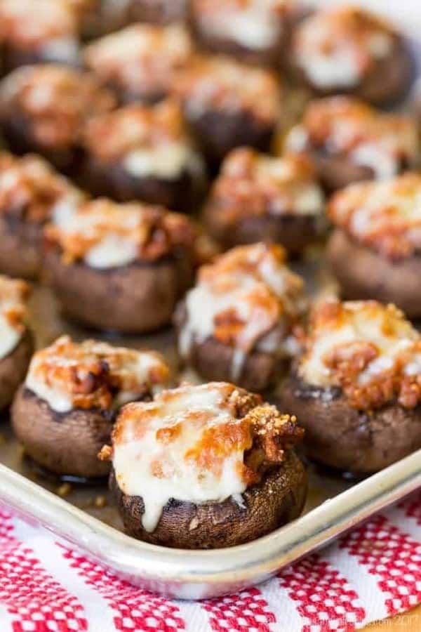 Bolognese ground beef stuffed mushroom caps on a cooking tray