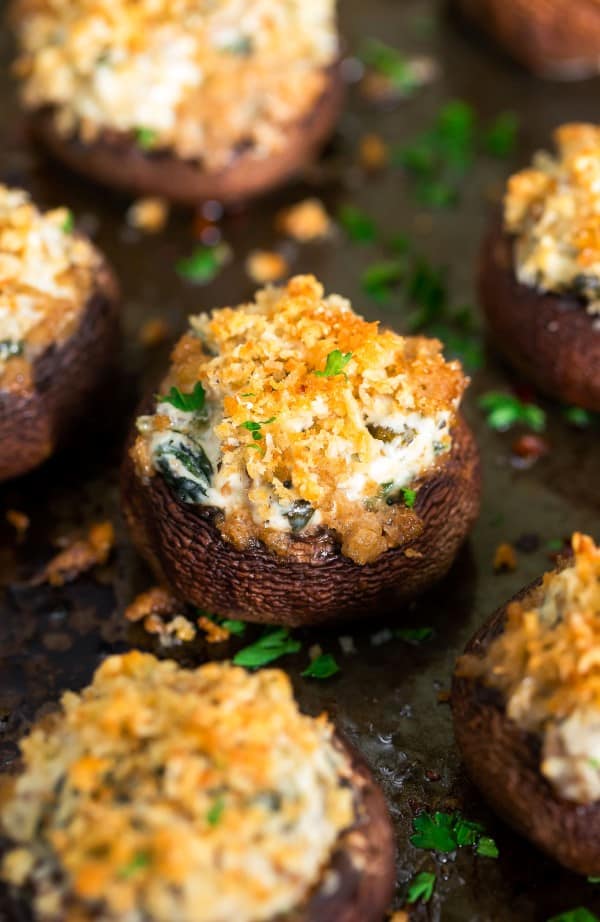Cheese spinach stuffed mushrooms on a cooking tray
