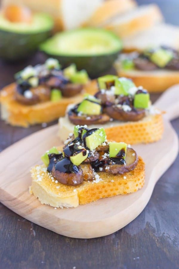 Mushroom, avocado and feta toasts on a serving platter