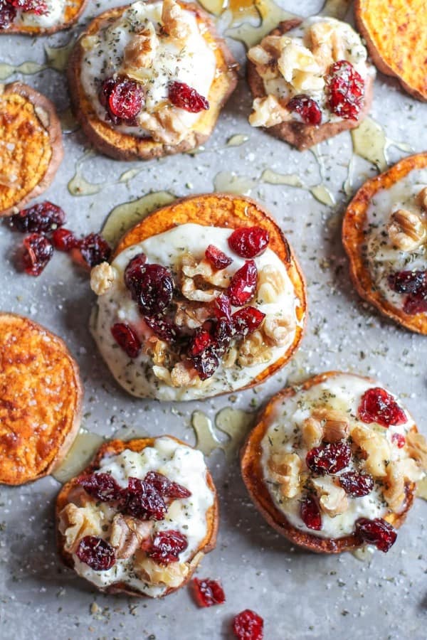 Sweet potato rounds with herbed ricotta and walnuts on a stone serving tray