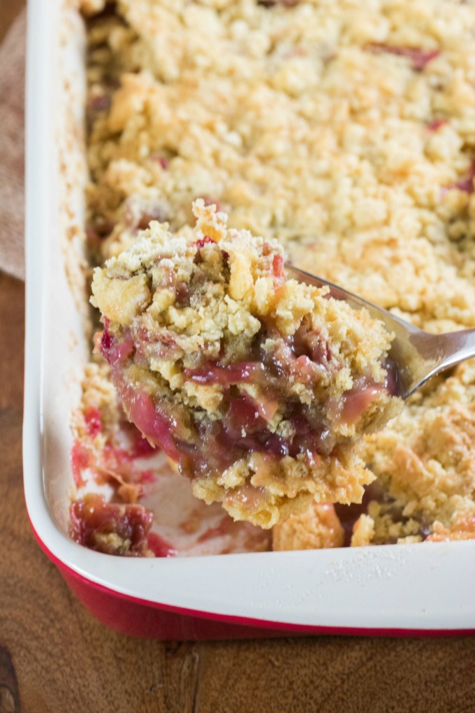 Scooping out Rhubarb Dump Cake from a pan