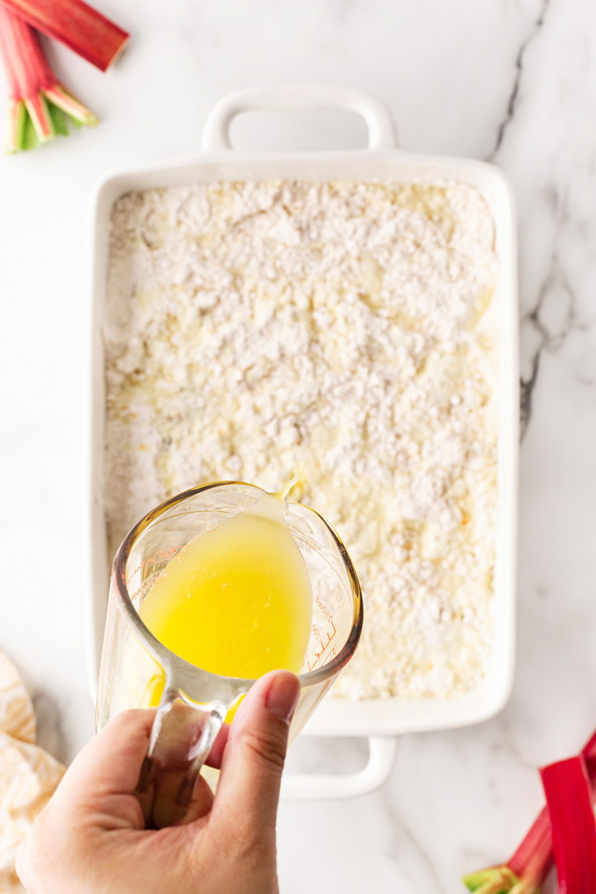 Pouring on butter. 