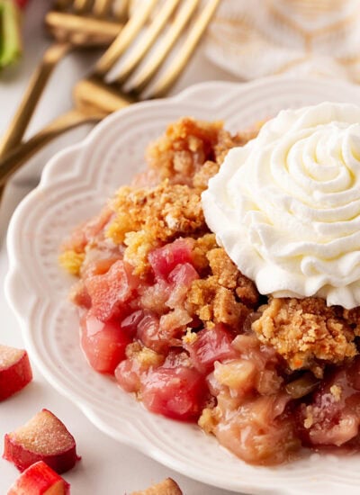 Rhubarb Dump Cake on a plate with whipped cream.