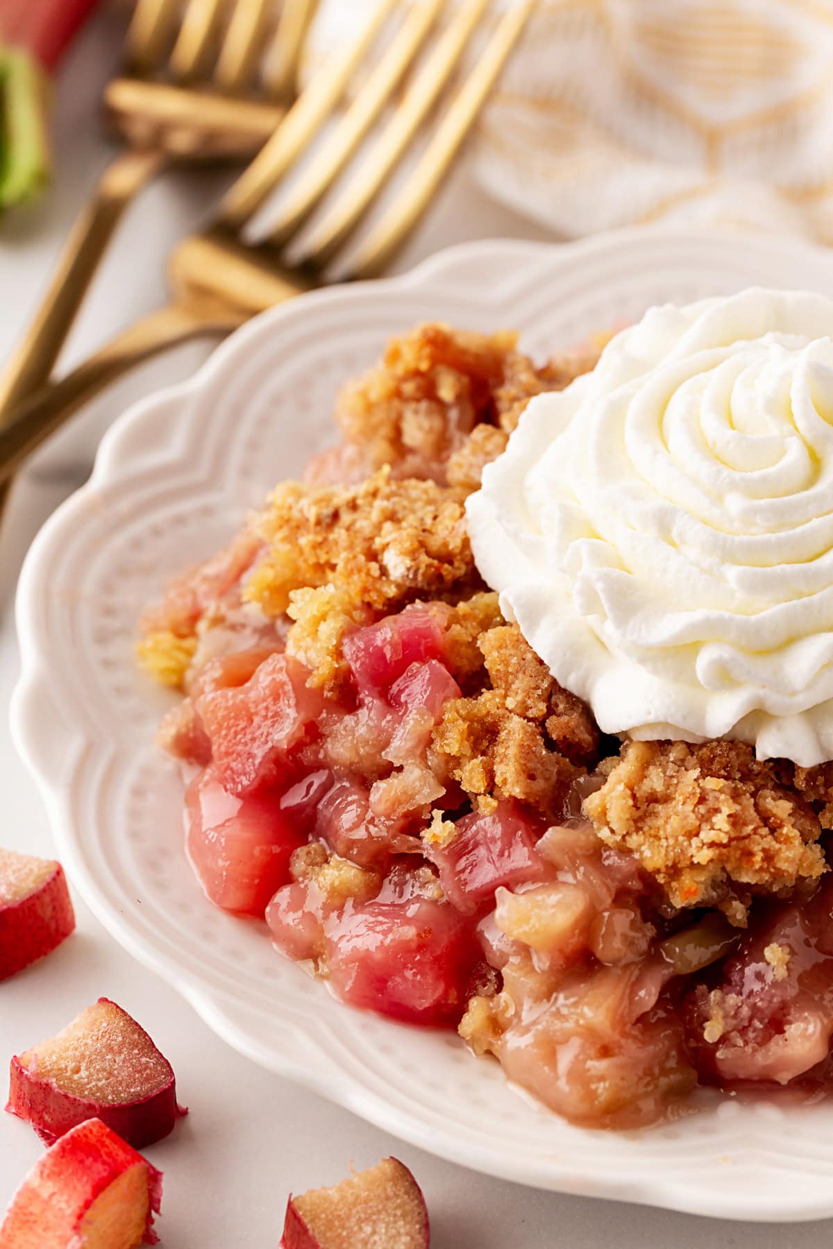 Rhubarb Dump Cake on a plate with whipped cream. 