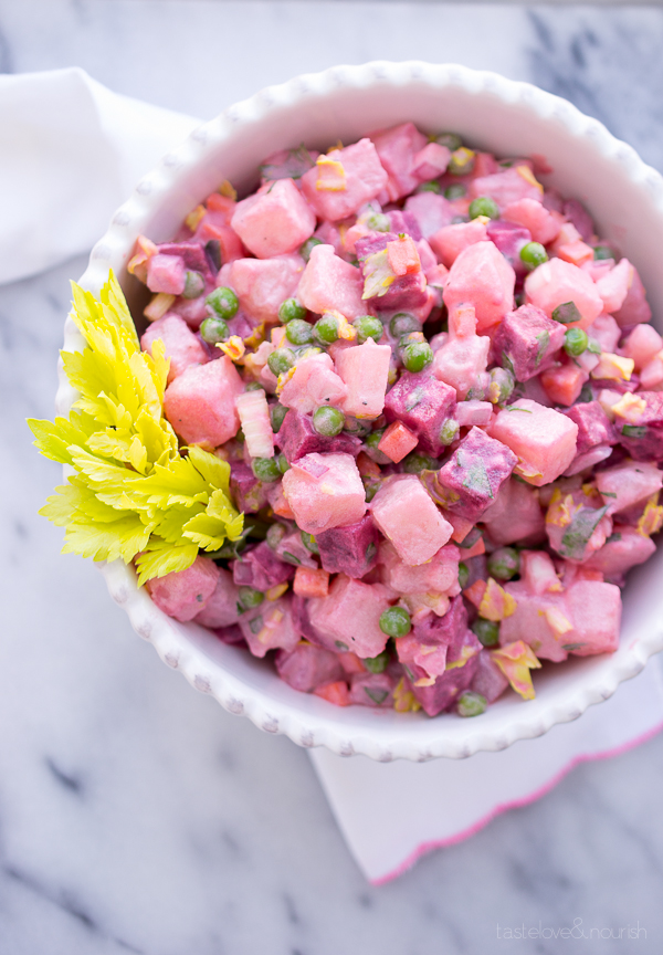 Beet and potato salad in a white serving bowl