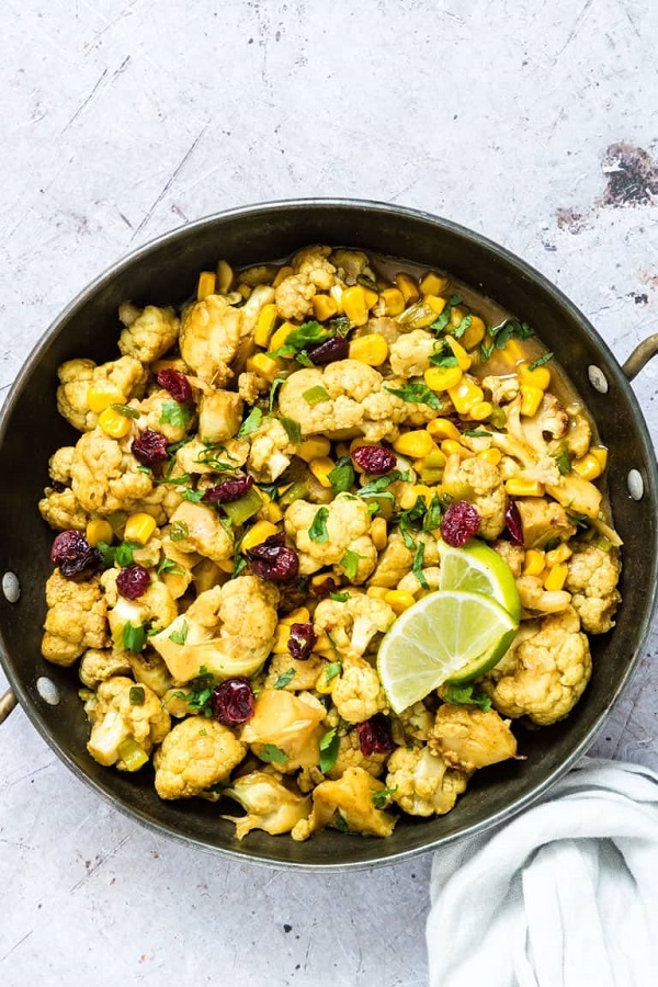 One Pan Cauliflower Curry in a skillet with lime wedge