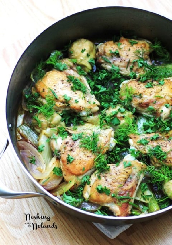 Chicken, Fennel and Artichokes in a skillet garnished with fennel fronds 