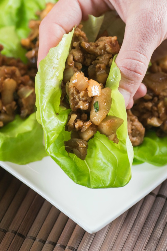 Chicken Lettuce Wraps being picked up taco style. 