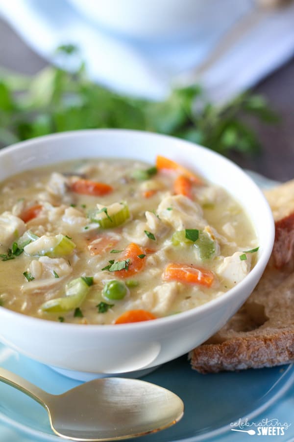 Easy Creamy Chicken Wild Rice Soup in a bowl with a spoon and bread