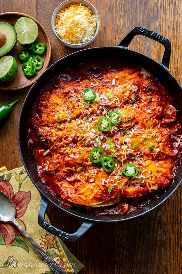 Easy Chicken Enchiladas Recipe in a skillet with jalapeno slices 