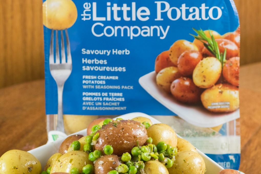 The Little Potato Company's Microwave Pack with potatoes and peas in a bowl in the forefront