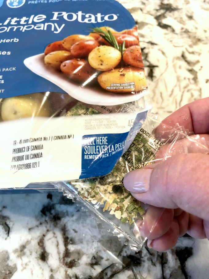 Removing the seasoning pack from The Little Potato Company's Microwave Pack