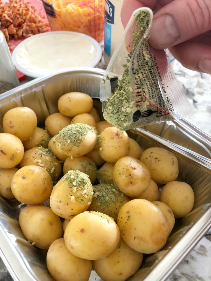 Sprinkling on the seasoning pack from the Little potatoes package