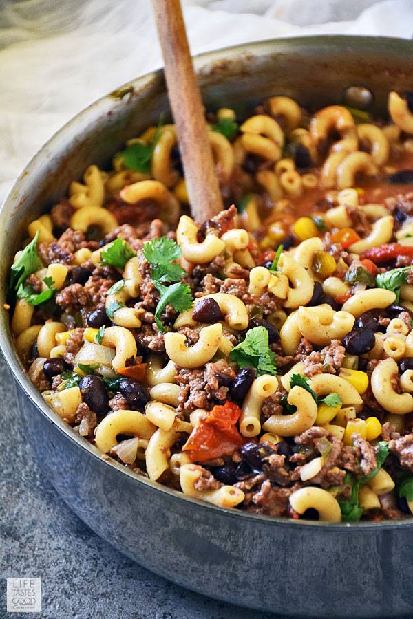 One Pot Taco Pasta Skillet in a skillet with a wooden spoon