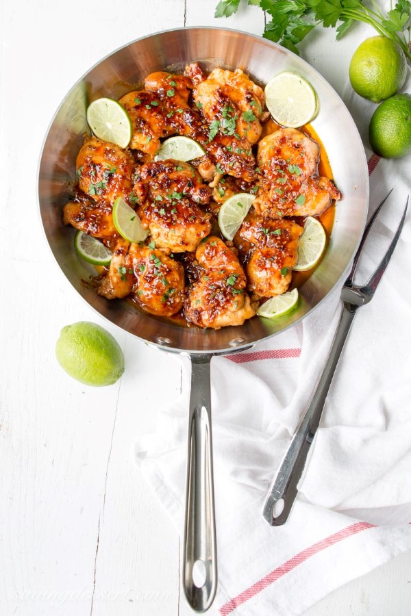 Spicy Honey Lime Chicken Thigh Recipe in a skillet with a white background